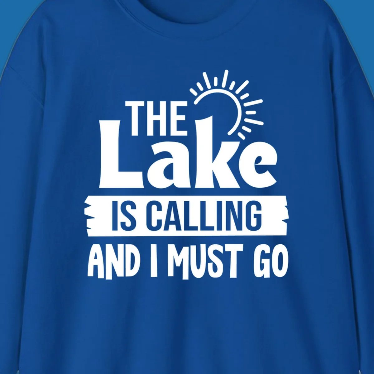 The Lake Is Calling And I Must Go text with a sun graphic. lake-calling-go