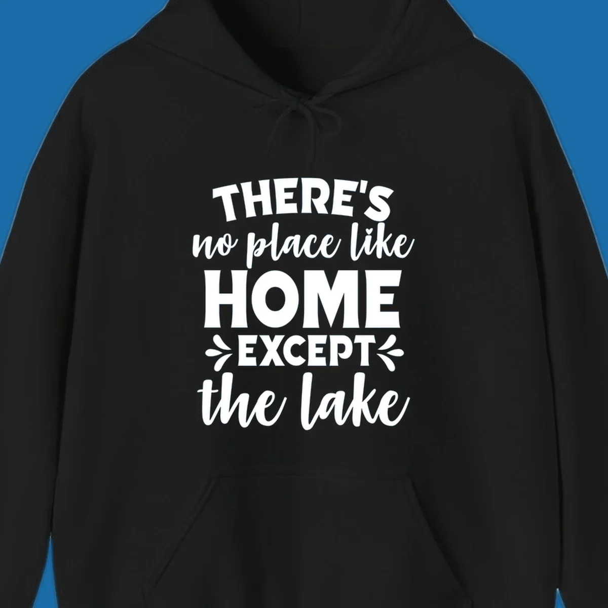 Typography design with the phrase "There's No Place Like Home Except The Lake" for lake-life apparel.