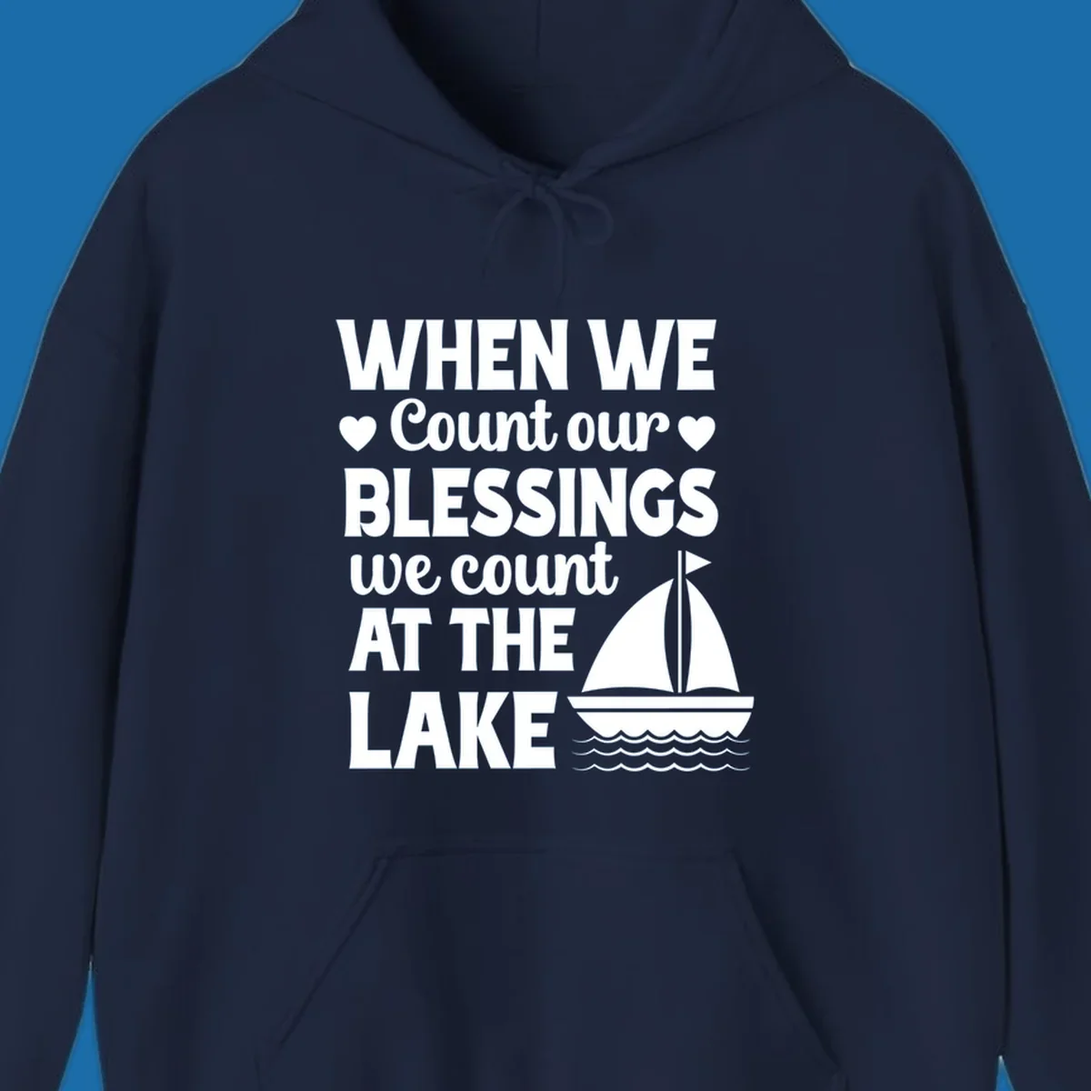 Text reads 'When We Count Our Blessings We Count At The Lake' with a sailboat graphic, lake-life-blessings design.