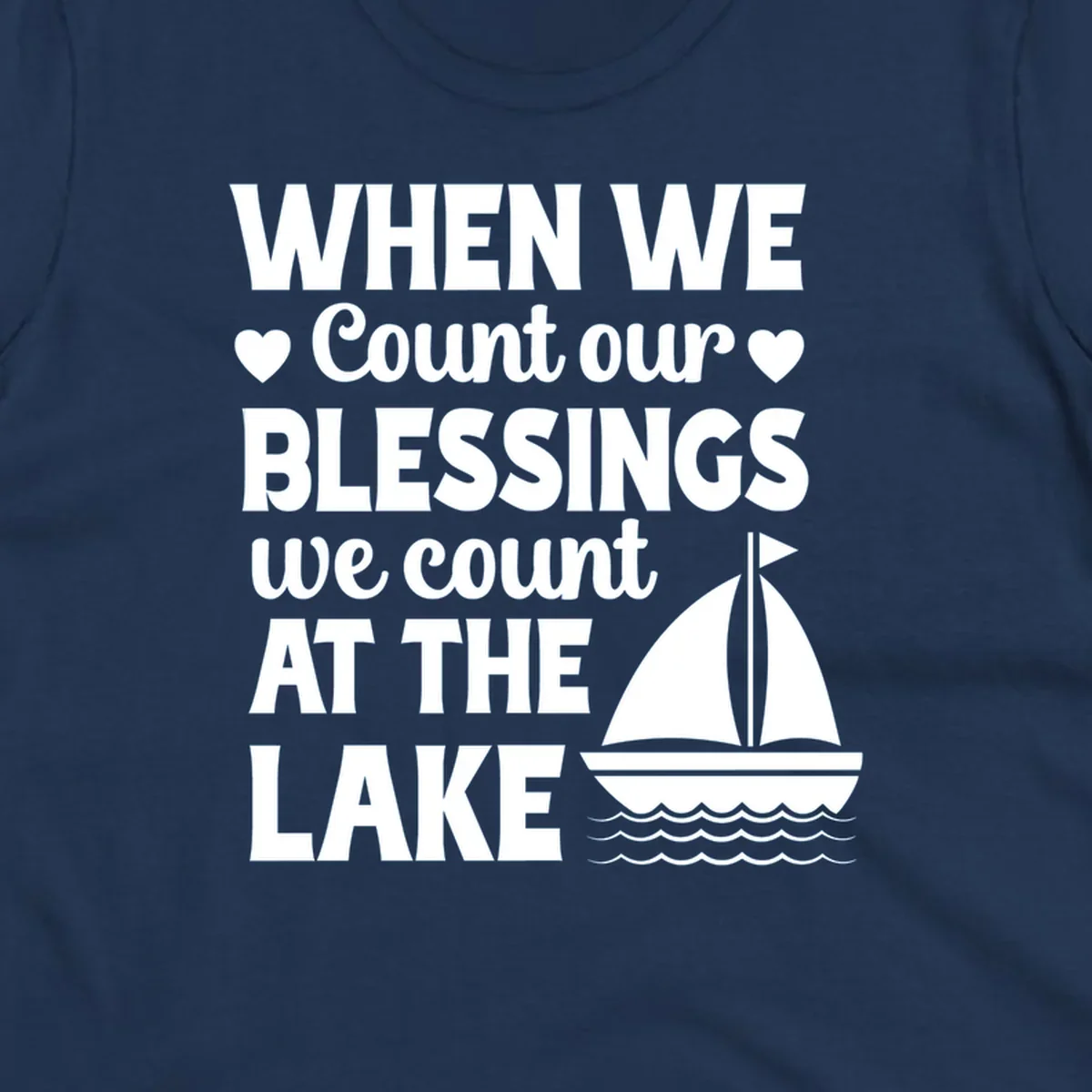 Text reads 'When We Count Our Blessings We Count At The Lake' with a sailboat graphic, lake-life-blessings design.