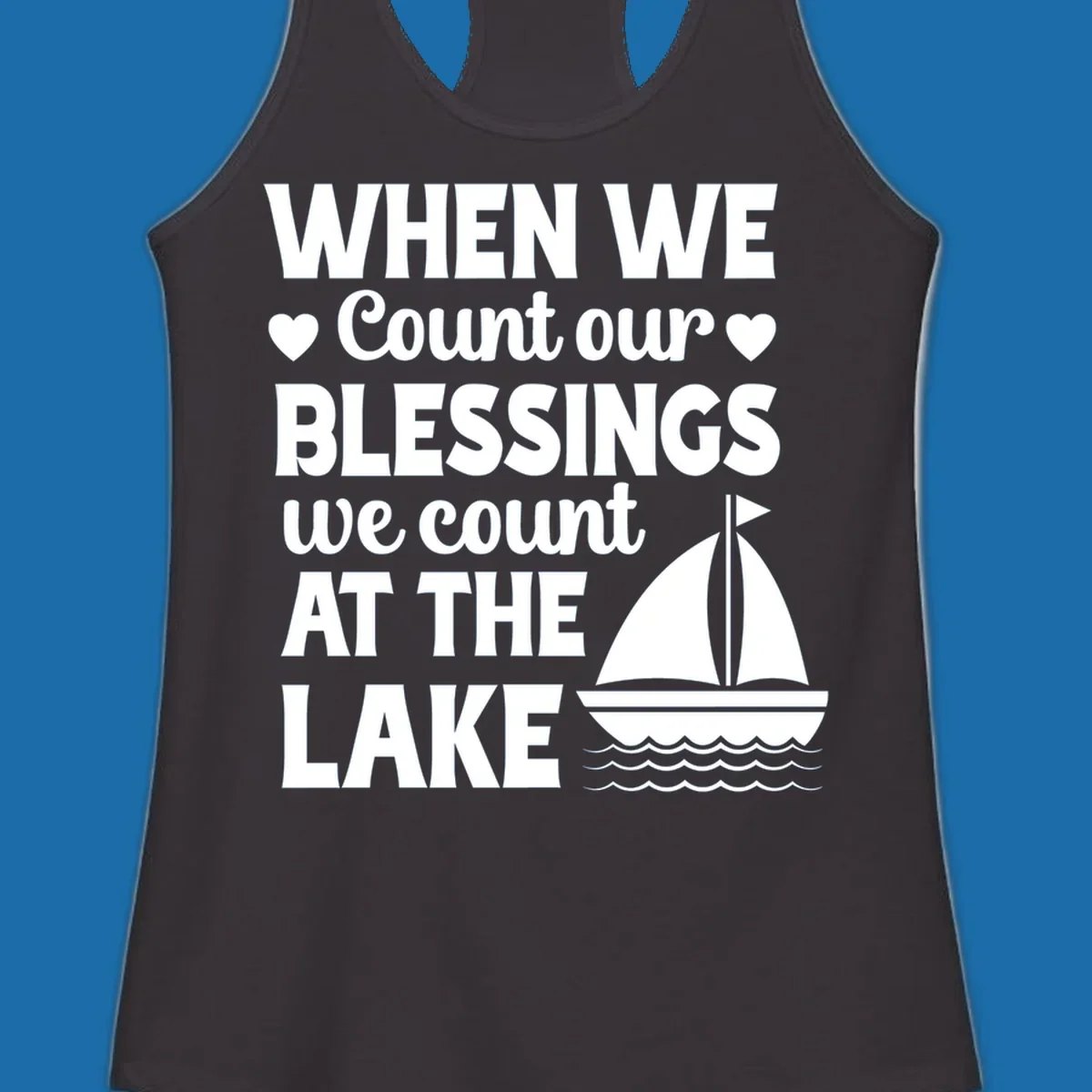 Text reads 'When We Count Our Blessings We Count At The Lake' with a sailboat graphic, lake-life-blessings design.