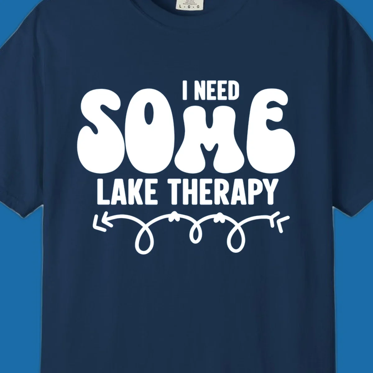 White "I Need Some Lake Therapy" text design with decorative wavy arrow line.