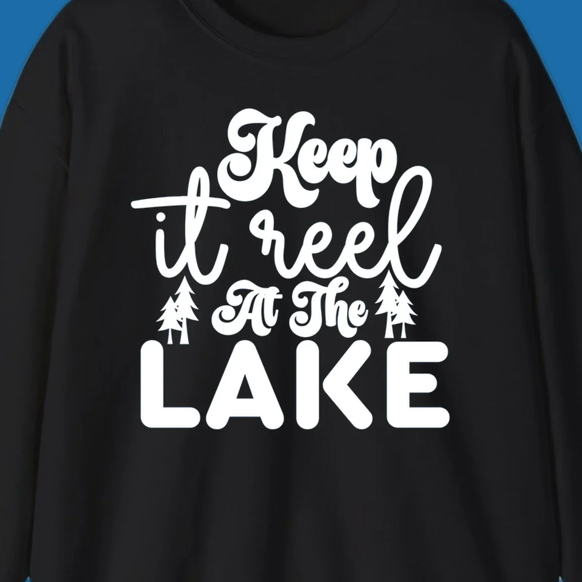 Keep it reel at the lake typography design with pine trees.