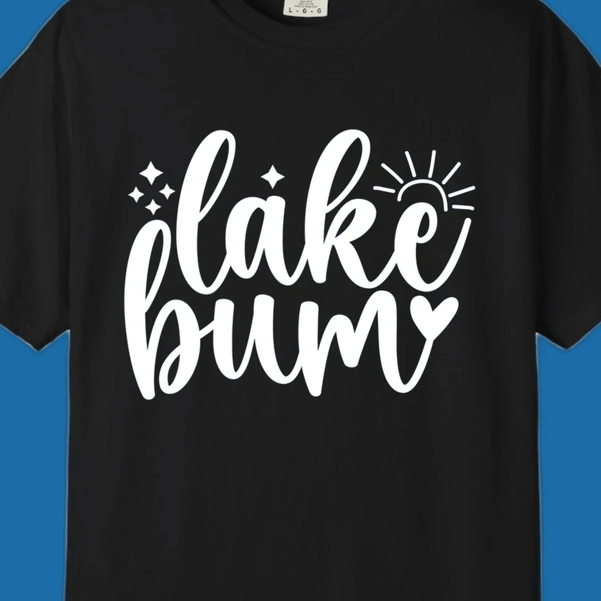 Lake bum text design with sun, sparkles, and heart graphic.