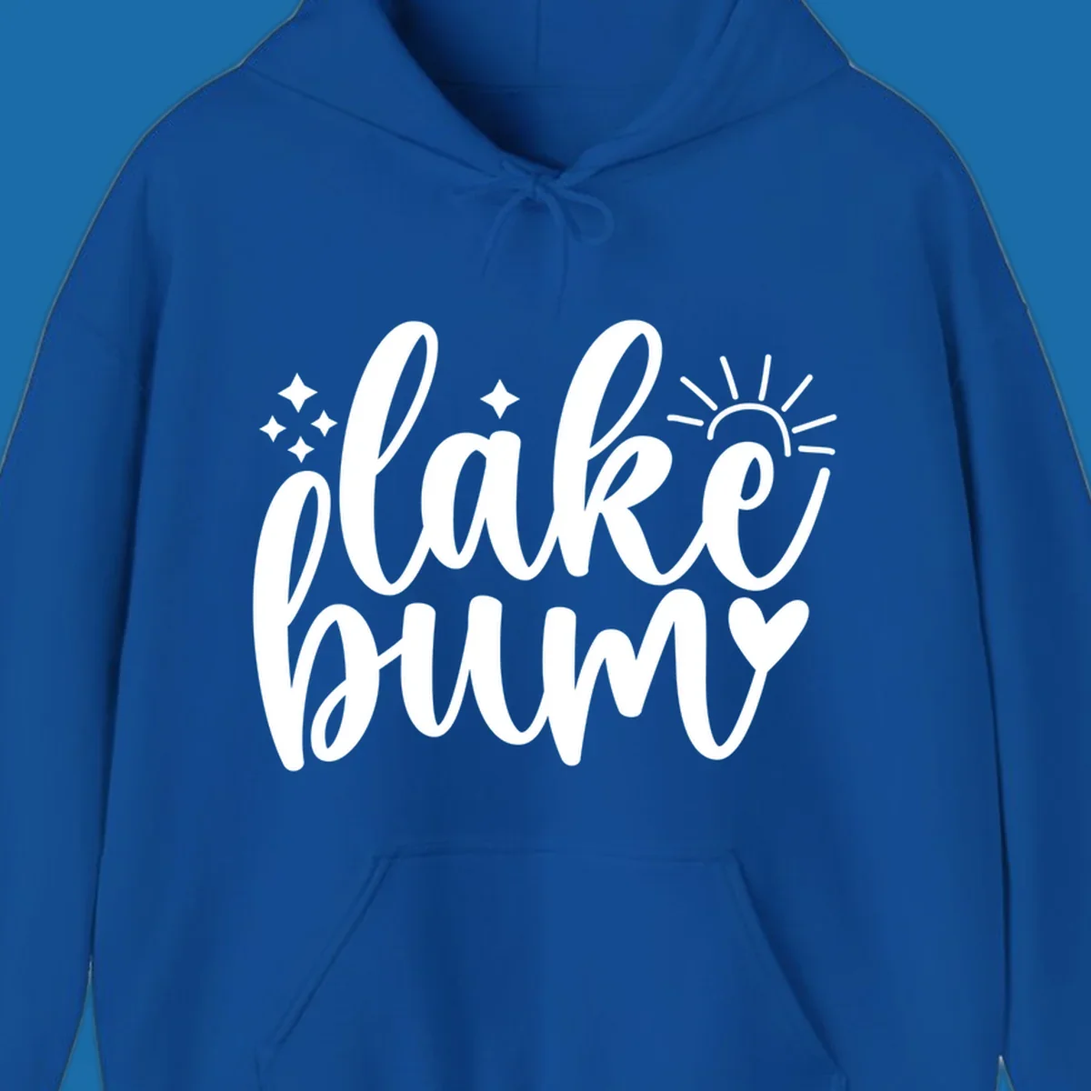 Lake bum text design with sun, sparkles, and heart graphic.