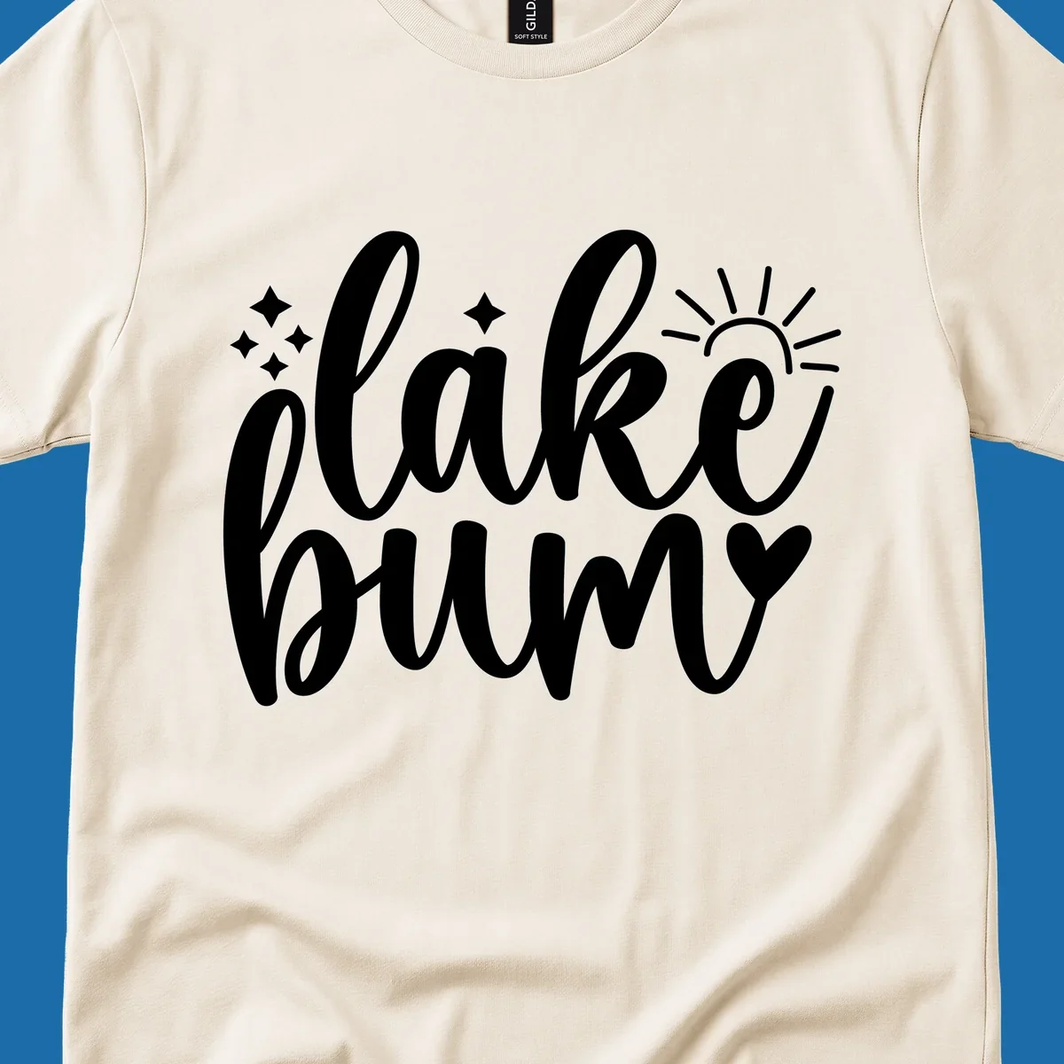 Lake bum text design with sun, sparkles, and heart graphic.