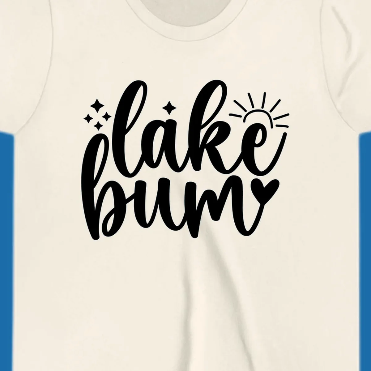 Lake bum text design with sun, sparkles, and heart graphic.