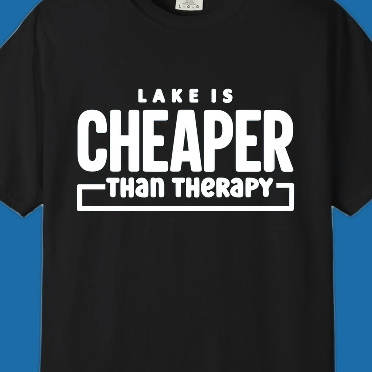 White text reads "LAKE IS CHEAPER THAN THERAPY", a humorous phrase about lake life.