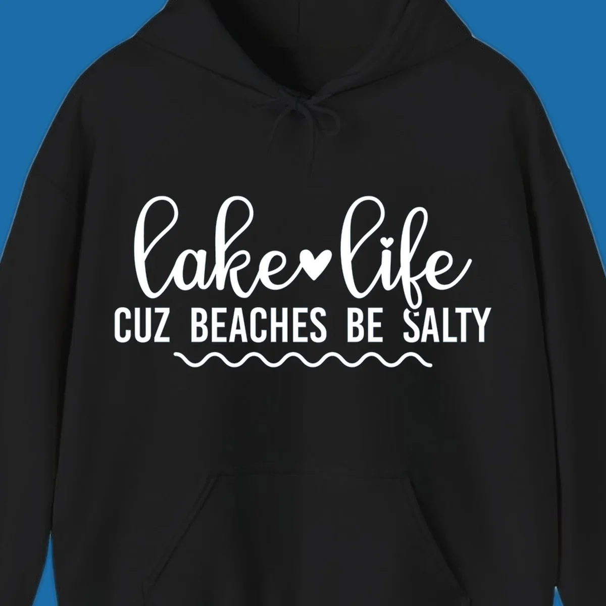 Lake life cuz beaches be salty text design with heart and wavy lines.