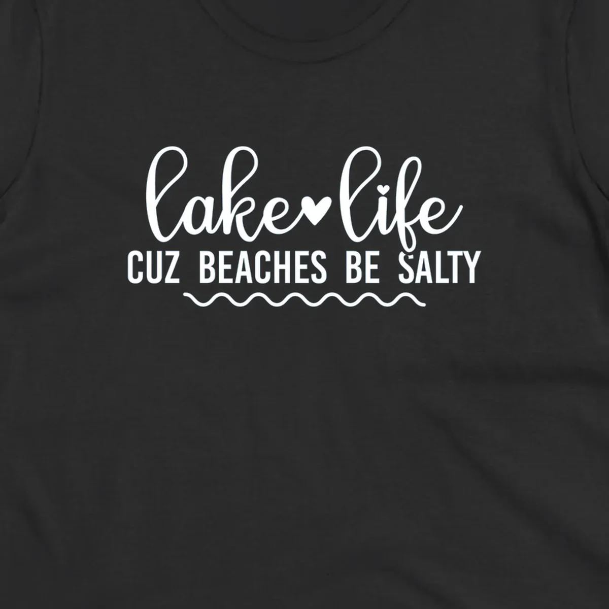 Lake life cuz beaches be salty text design with heart and wavy lines.