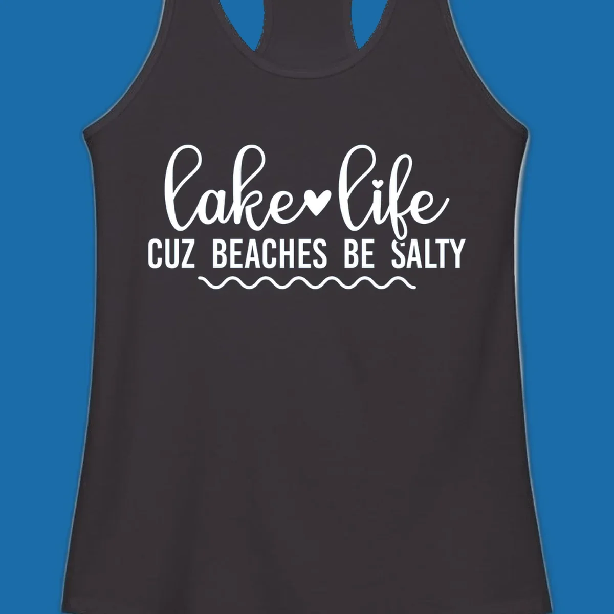 Lake life cuz beaches be salty text design with heart and wavy lines.