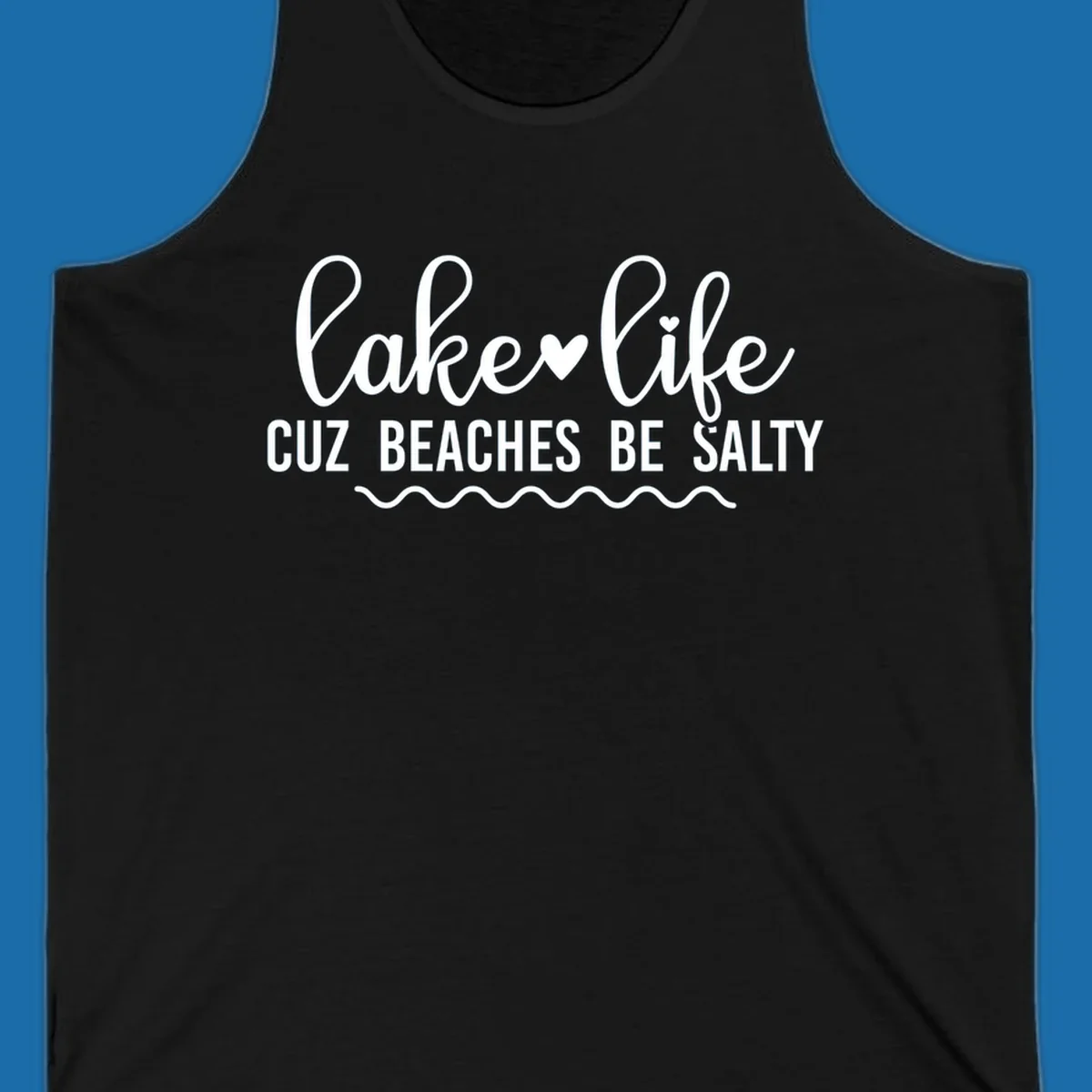 Lake life cuz beaches be salty text design with heart and wavy lines.