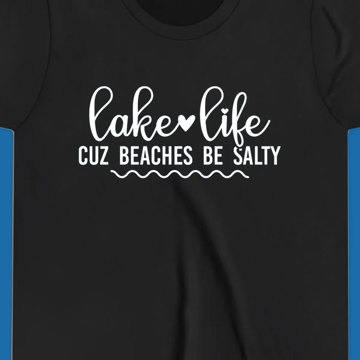 Lake life cuz beaches be salty text design with heart and wavy lines.