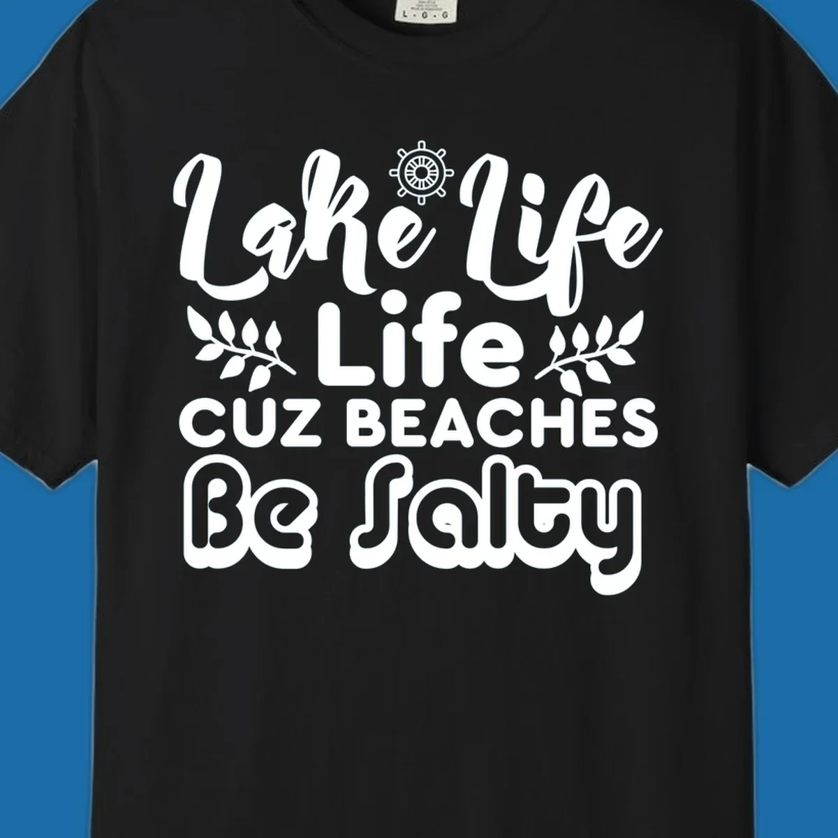 Lake Life Cuz Beaches Be Salty typography design with ship wheel and leaf accents.
