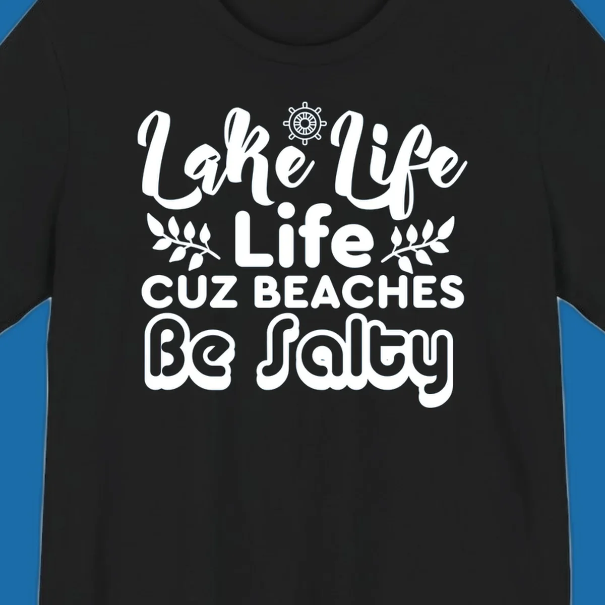 Lake Life Cuz Beaches Be Salty typography design with ship wheel and leaf accents.