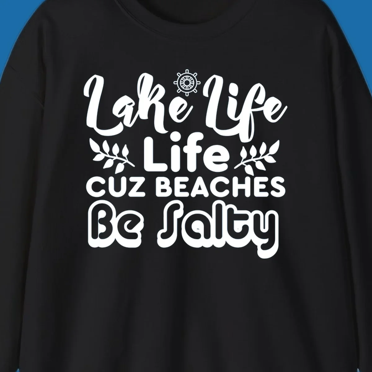 Lake Life Cuz Beaches Be Salty typography design with ship wheel and leaf accents.