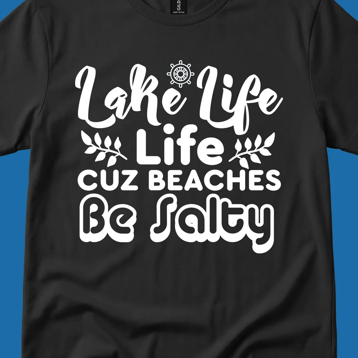 Lake Life Cuz Beaches Be Salty typography design with ship wheel and leaf accents.