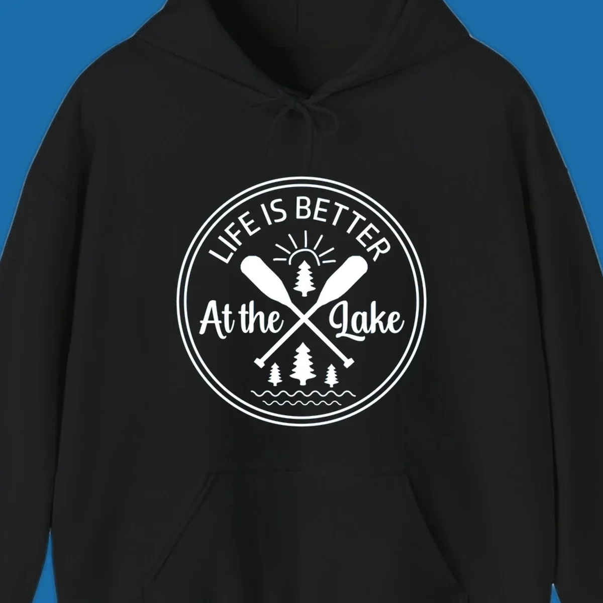 Life is better at the lake circular badge with oars, trees, sun, and waves.