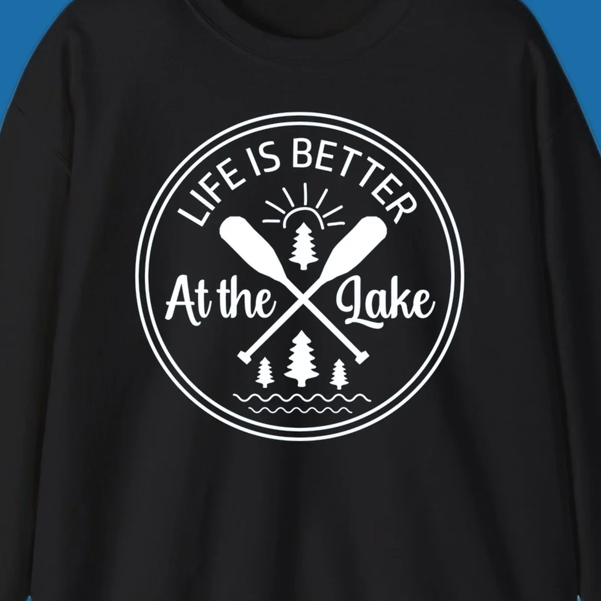 Life is better at the lake circular badge with oars, trees, sun, and waves.