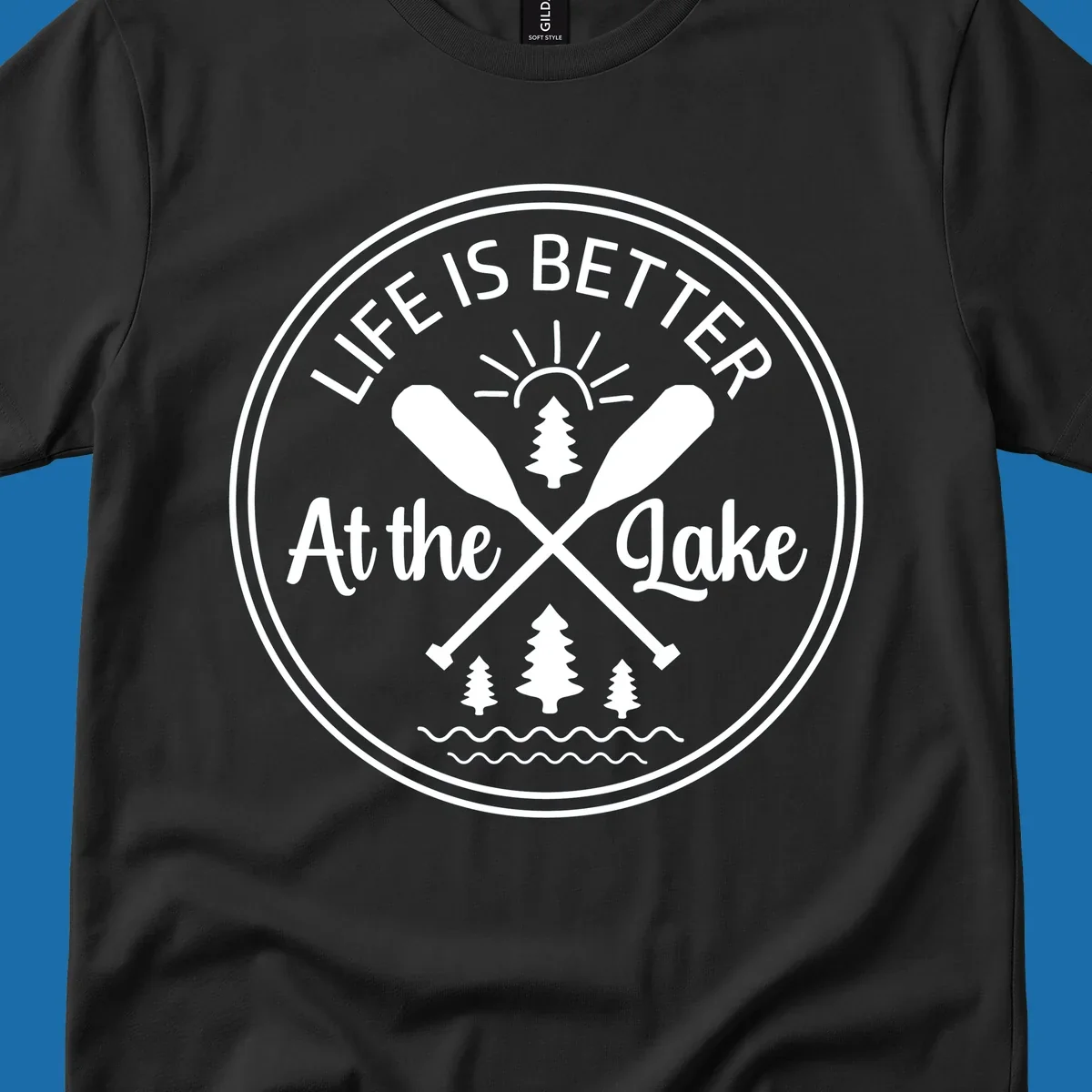 Life is better at the lake circular badge with oars, trees, sun, and waves.