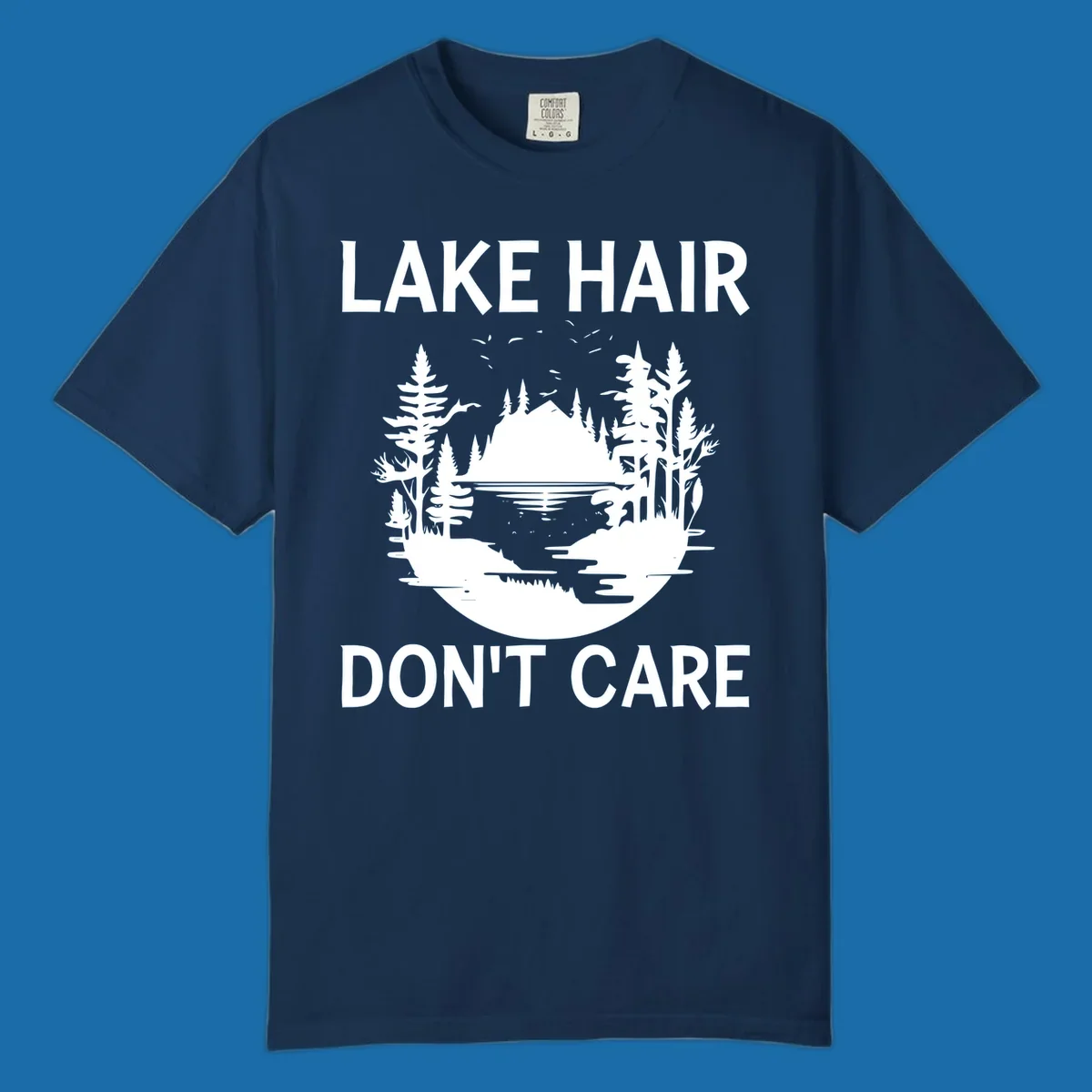 Lake Hair Don't Care design featuring a silhouette of a lake, trees, and mountains.