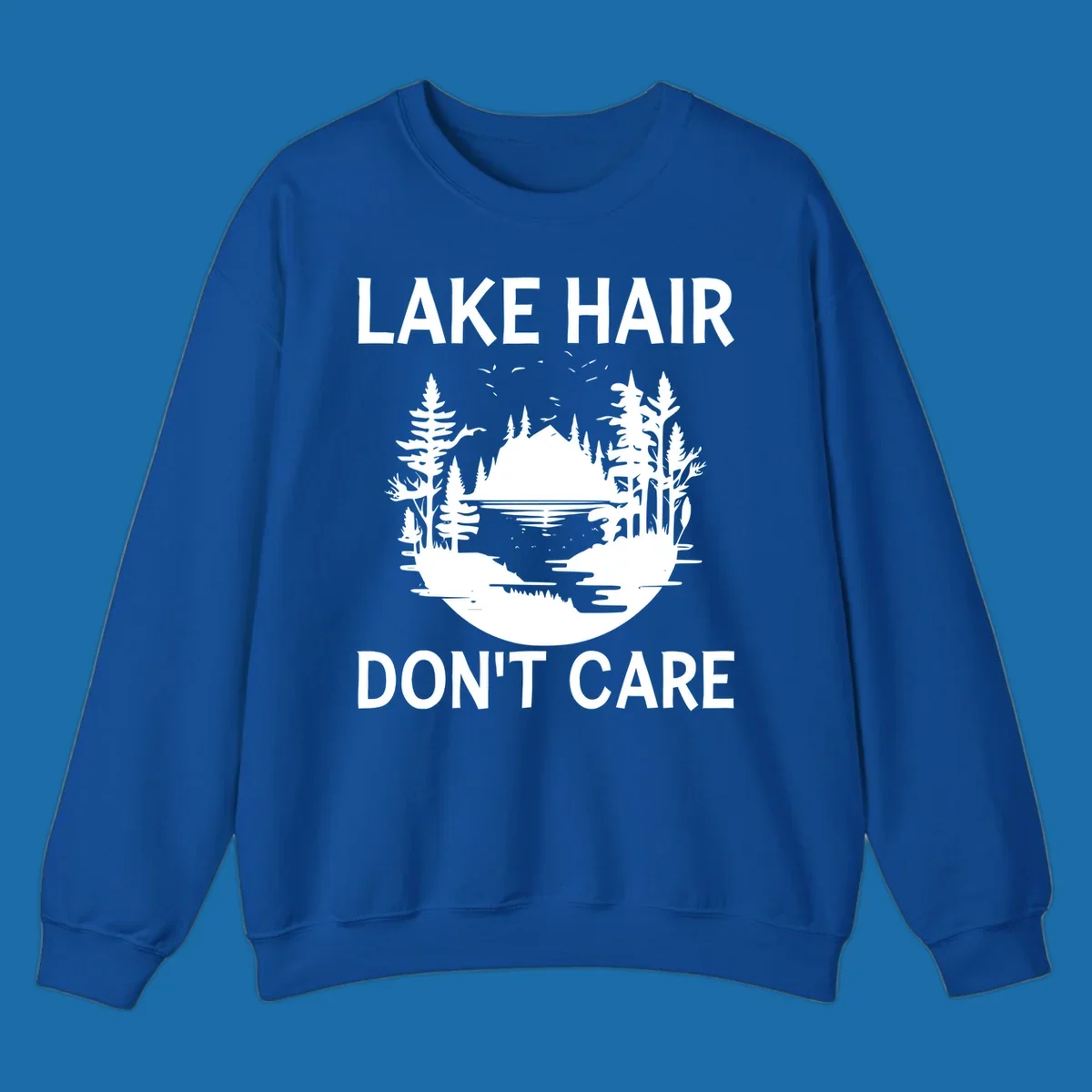 Lake Hair Don't Care design featuring a silhouette of a lake, trees, and mountains.