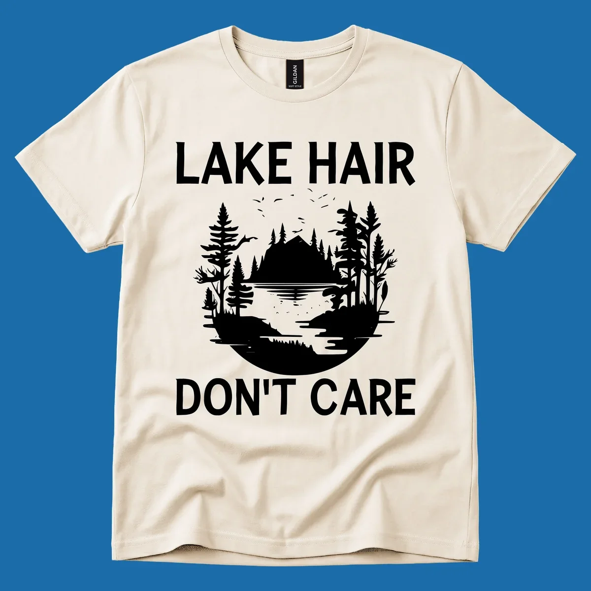 Lake Hair Don't Care design featuring a silhouette of a lake, trees, and mountains.