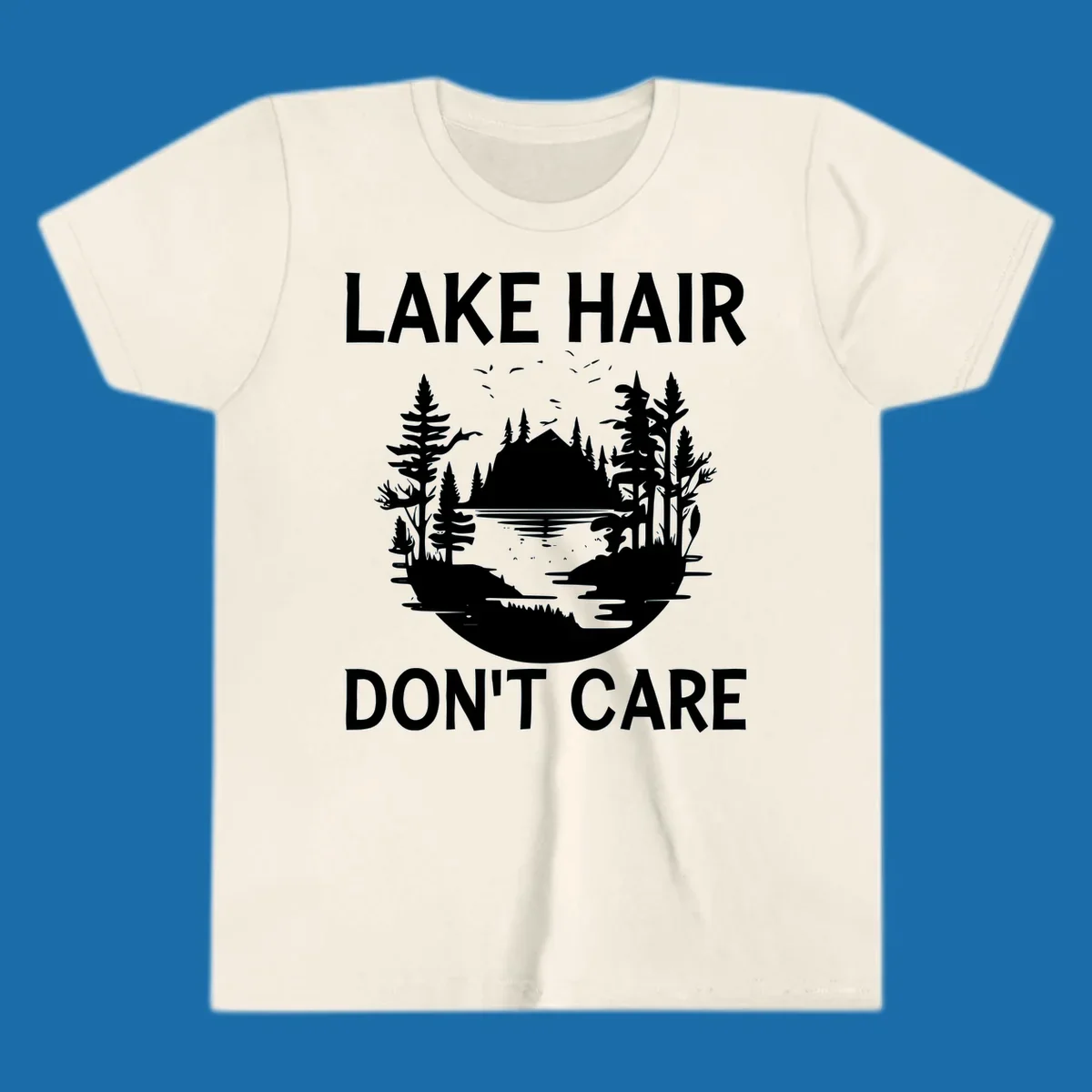 Lake Hair Don't Care design featuring a silhouette of a lake, trees, and mountains.
