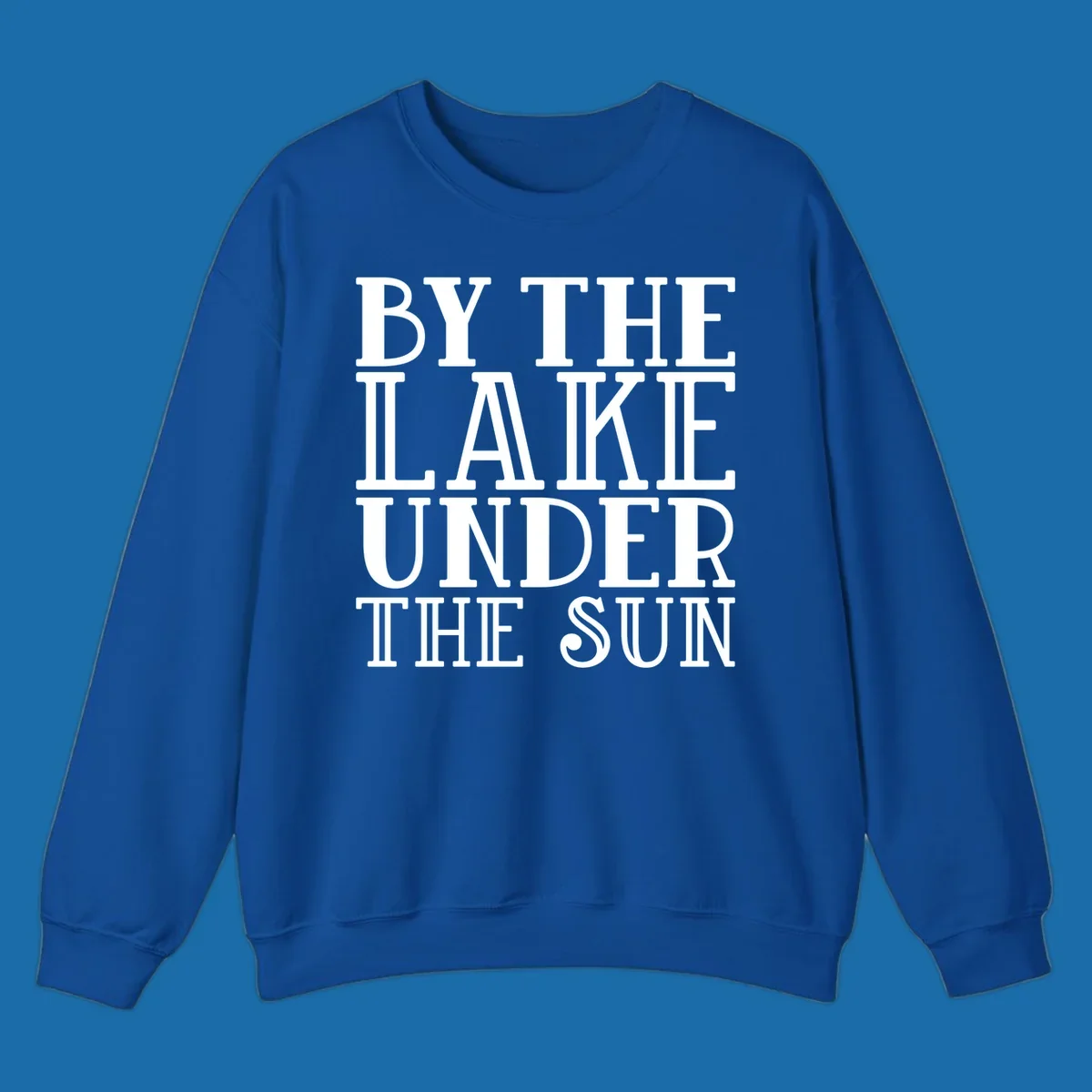 Text design 'BY THE LAKE UNDER THE SUN' in white serif font.