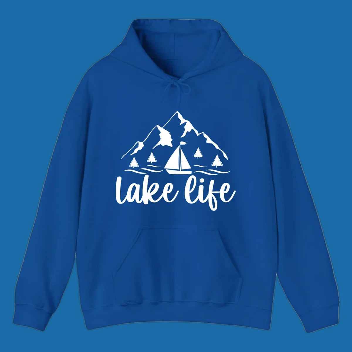 Lake life mountain sailboat scenic design with mountains, trees, sailboat, and text.