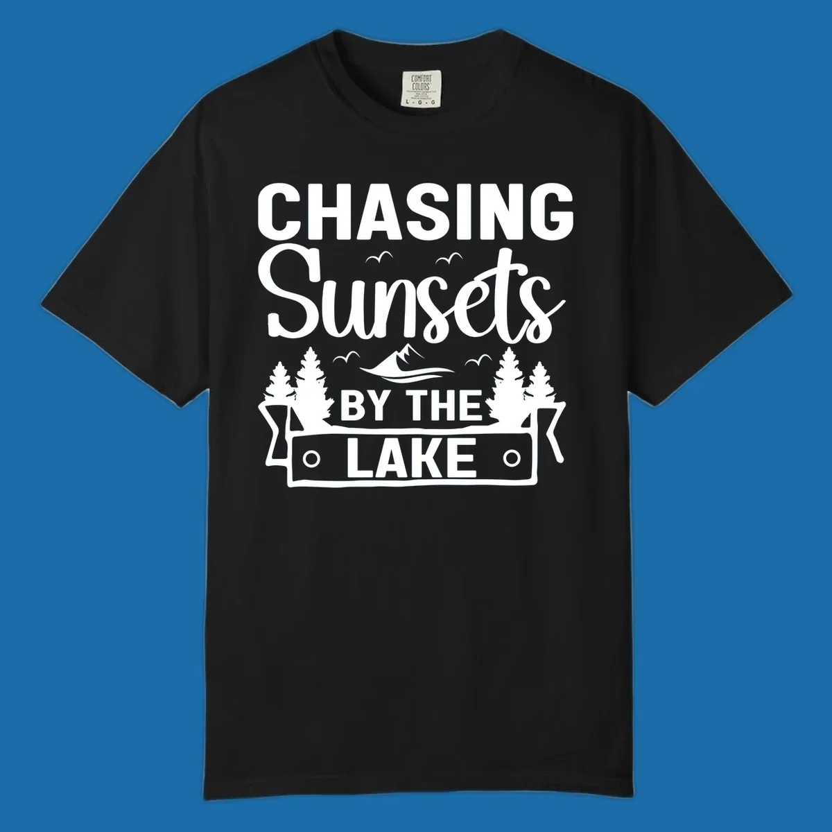 Chasing sunsets by the lake design with text, trees, mountains, and birds.