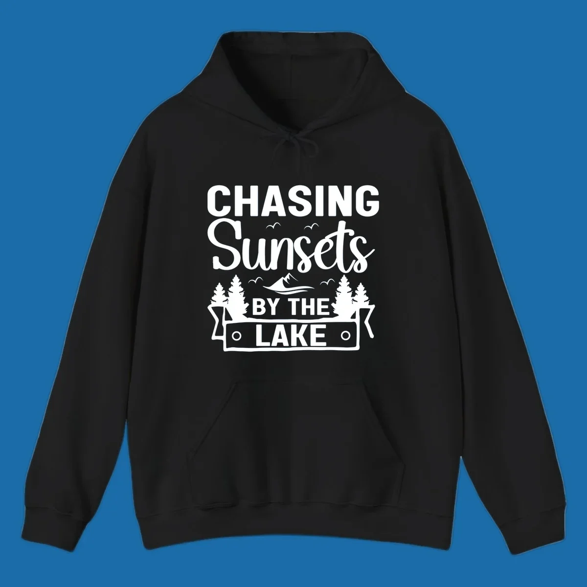 Chasing sunsets by the lake design with text, trees, mountains, and birds.