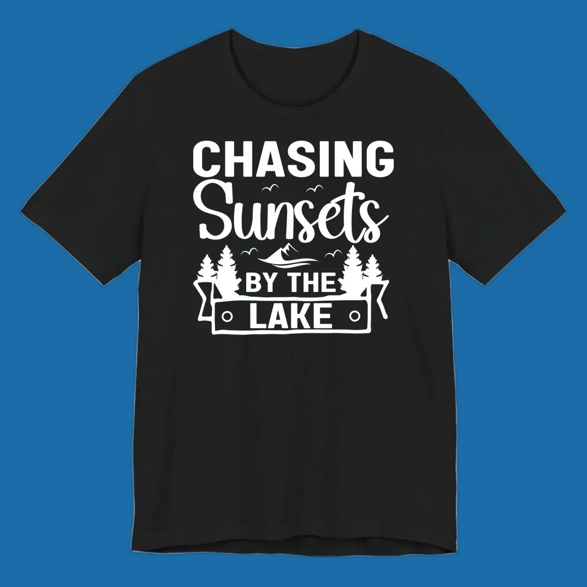 Chasing sunsets by the lake design with text, trees, mountains, and birds.