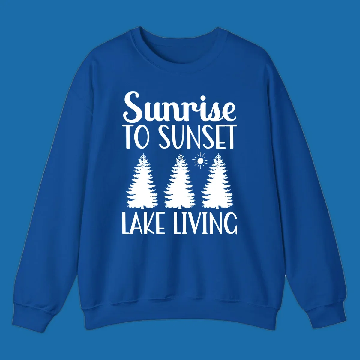 Sunrise to sunset lake living text with pine trees and sun graphic. lake-living-sunrise-sunset