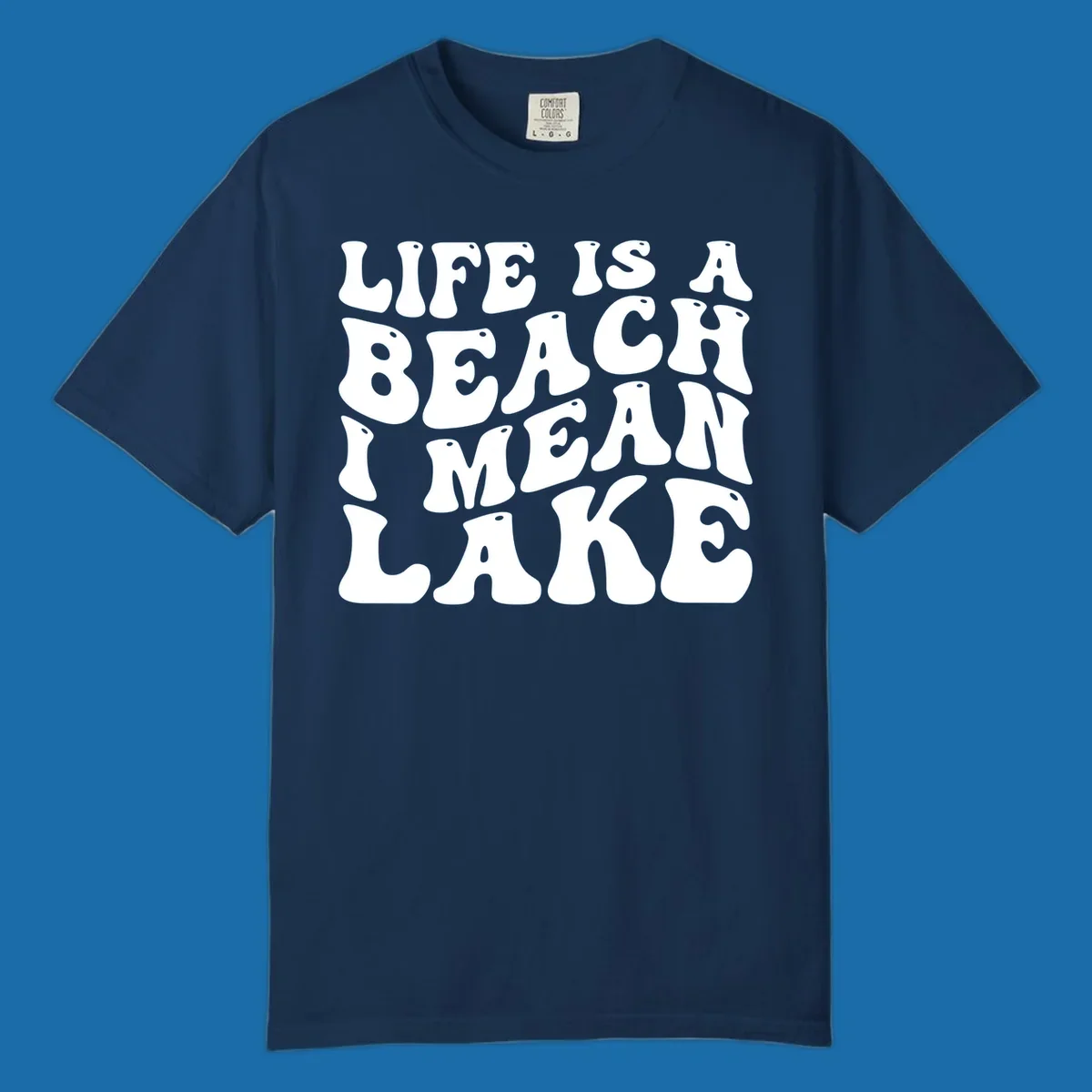 Retro typography design with the phrase "LIFE IS A BEACH I MEAN LAKE" for lake-themed apparel.