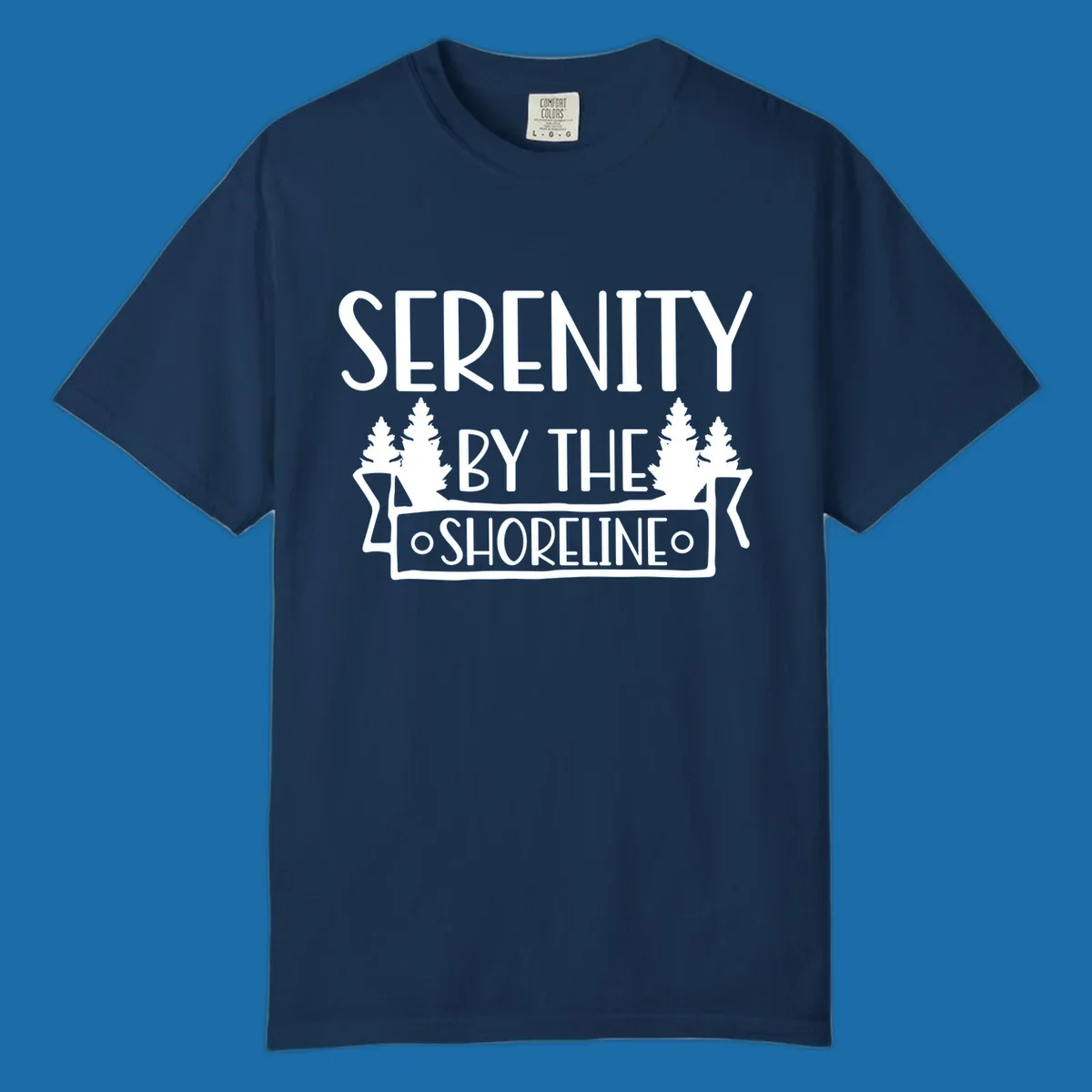 Serenity By The Shoreline text with pine trees and banner