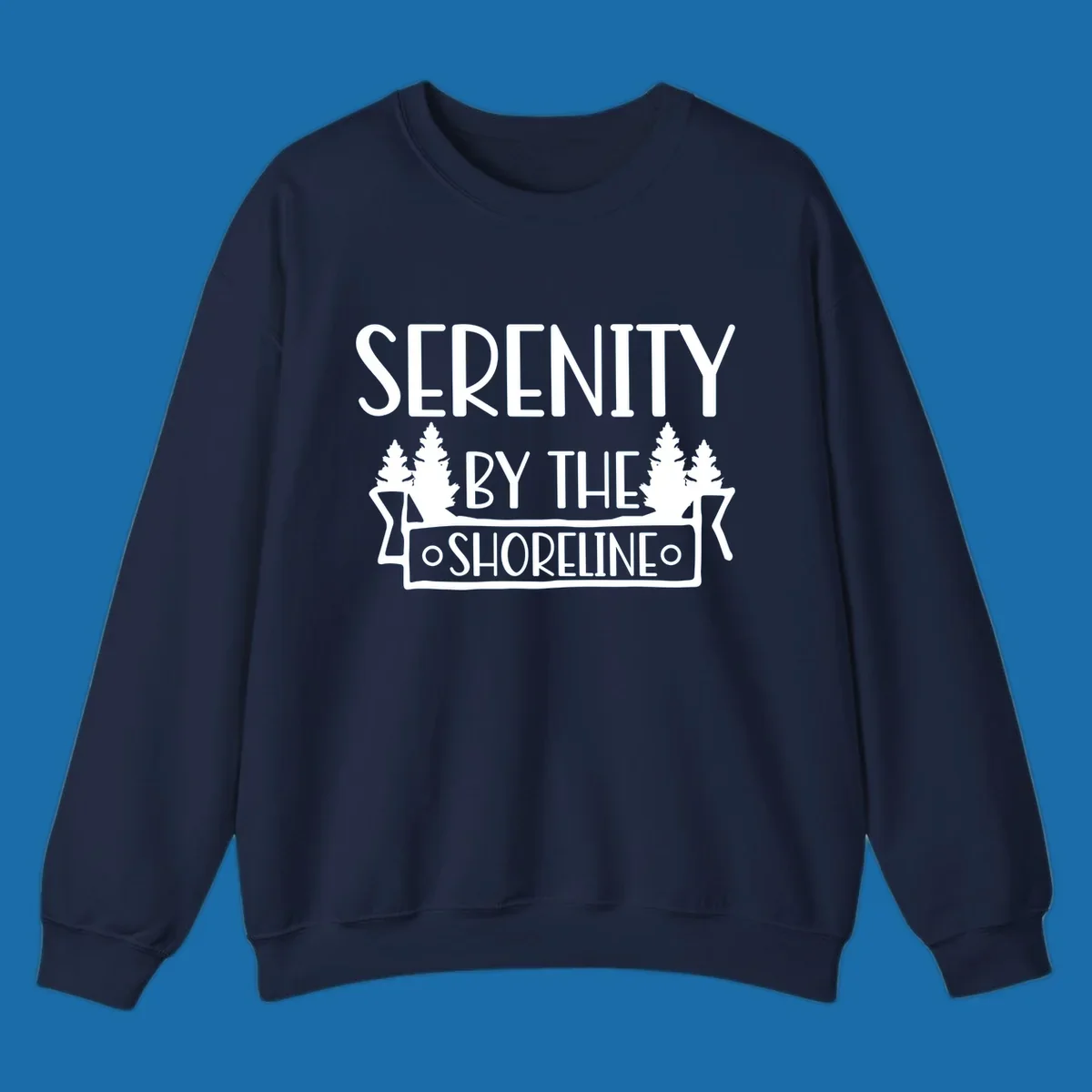 Serenity By The Shoreline text with pine trees and banner
