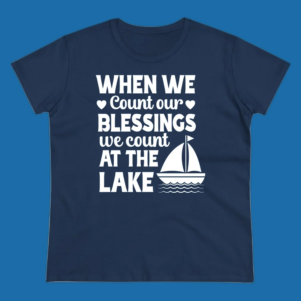 Text reads 'When We Count Our Blessings We Count At The Lake' with a sailboat graphic, lake-life-blessings design.