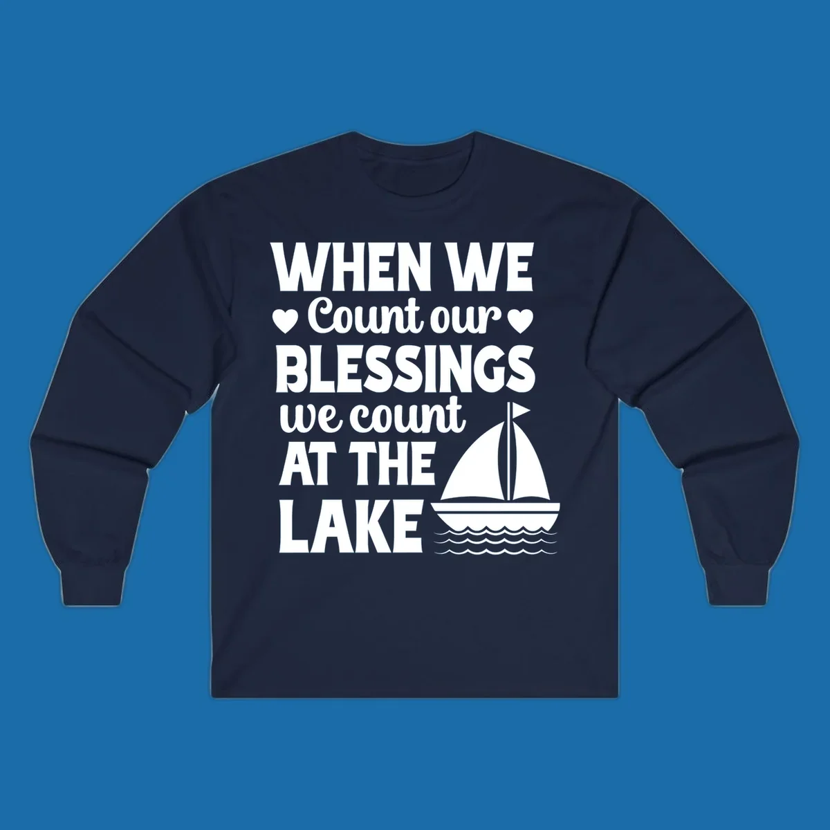 Text reads 'When We Count Our Blessings We Count At The Lake' with a sailboat graphic, lake-life-blessings design.