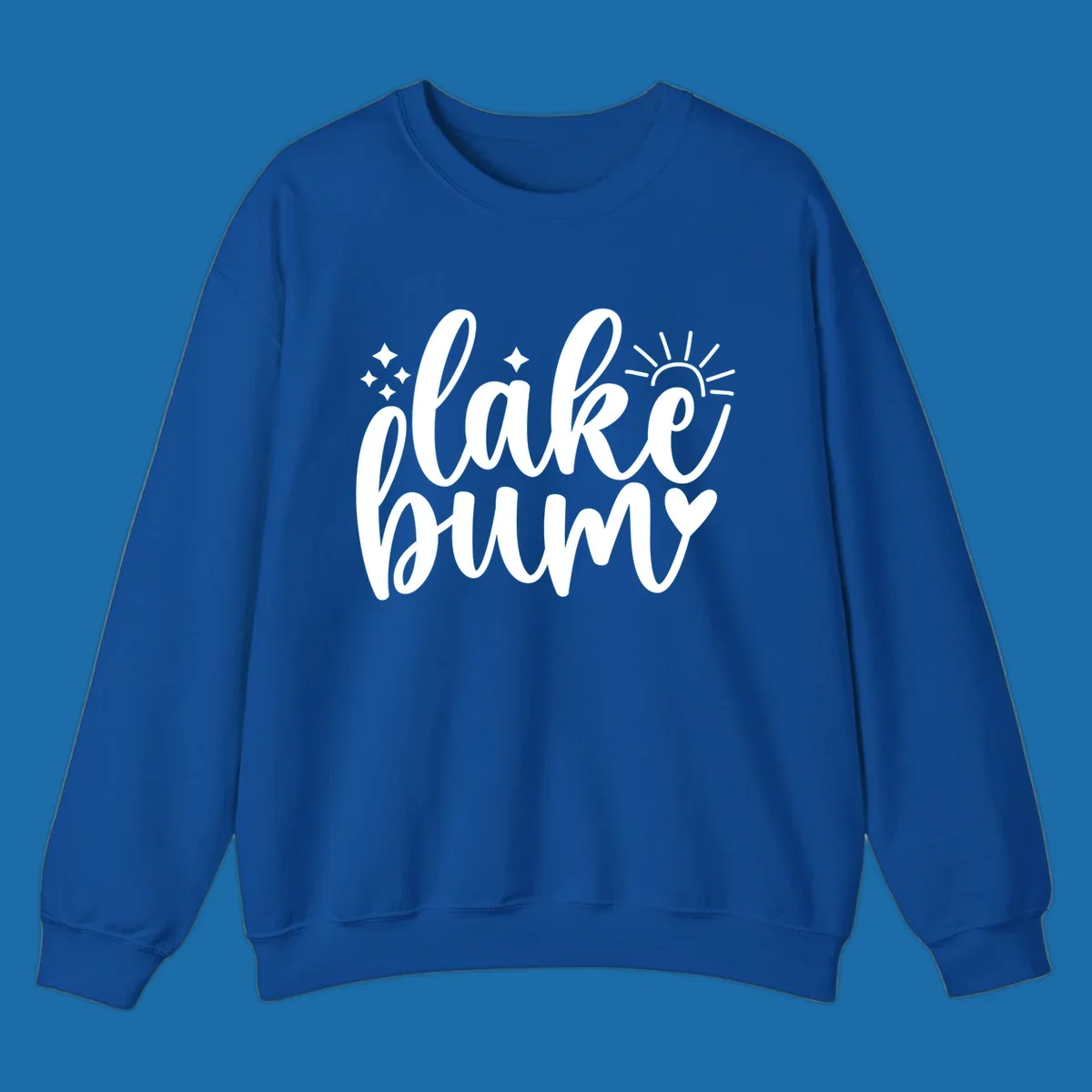 Lake bum text design with sun, sparkles, and heart graphic.