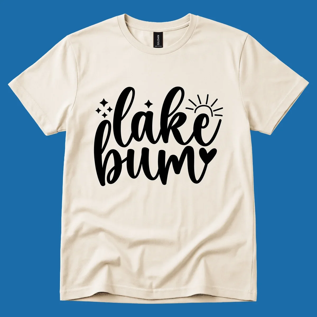 Lake bum text design with sun, sparkles, and heart graphic.