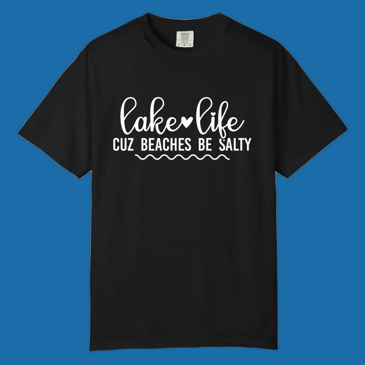 Lake life cuz beaches be salty text design with heart and wavy lines.