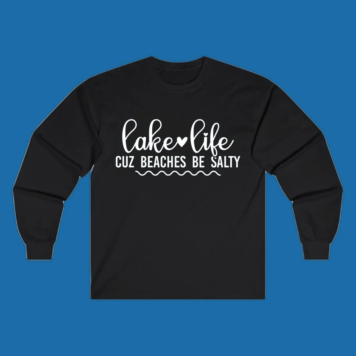 Lake life cuz beaches be salty text design with heart and wavy lines.