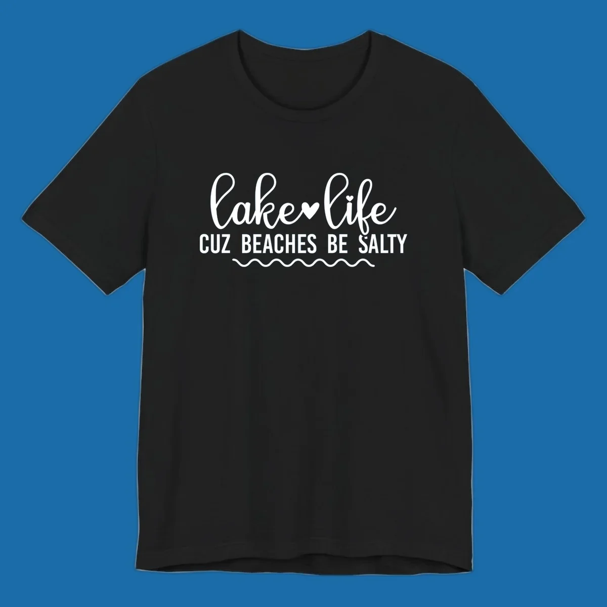 Lake life cuz beaches be salty text design with heart and wavy lines.