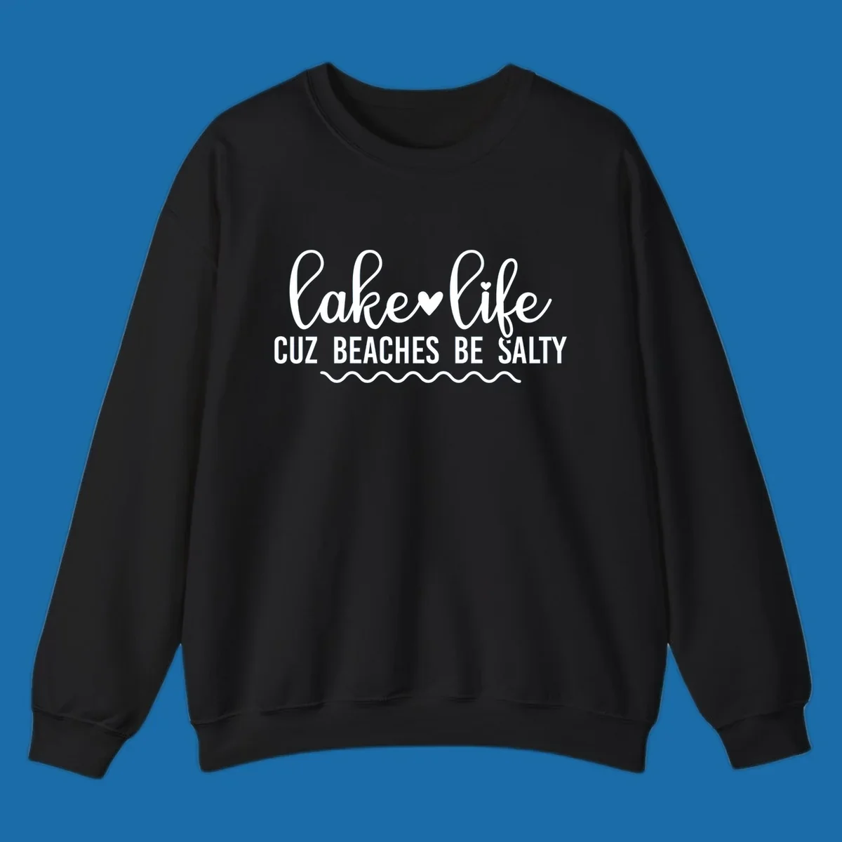 Lake life cuz beaches be salty text design with heart and wavy lines.