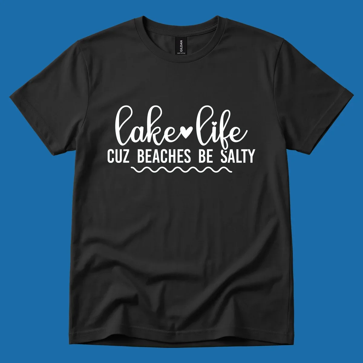Lake life cuz beaches be salty text design with heart and wavy lines.