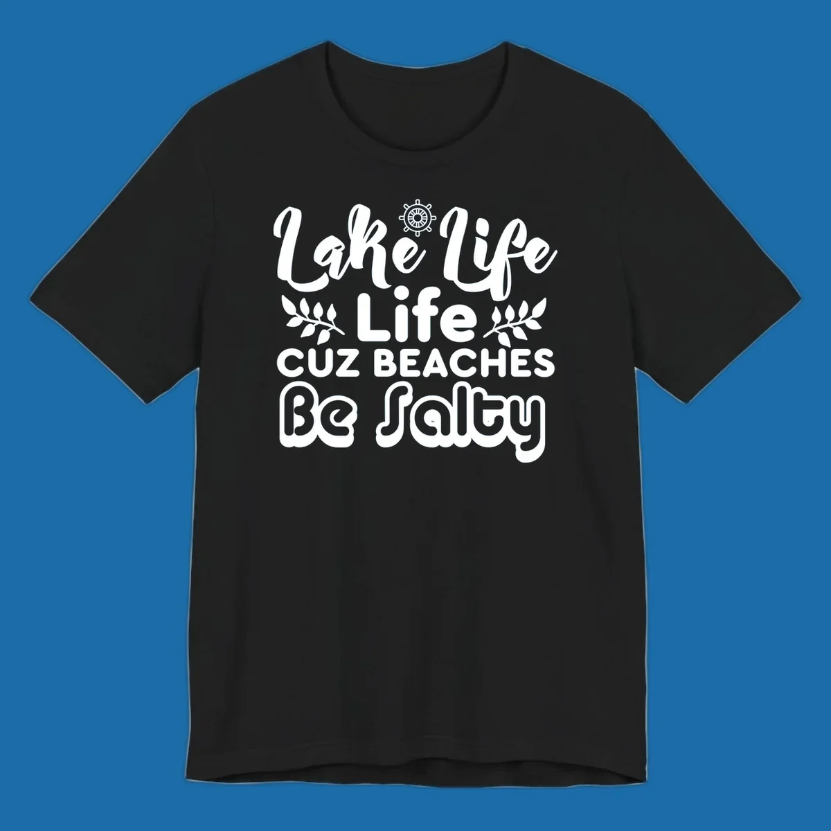 Lake Life Cuz Beaches Be Salty typography design with ship wheel and leaf accents.