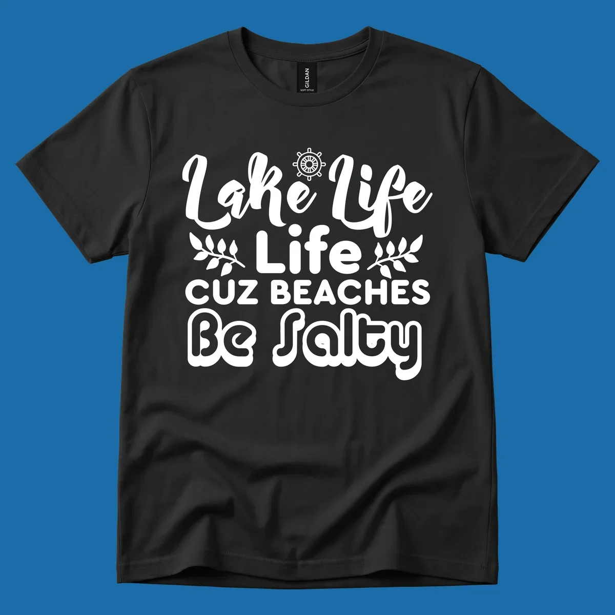 Lake Life Cuz Beaches Be Salty typography design with ship wheel and leaf accents.