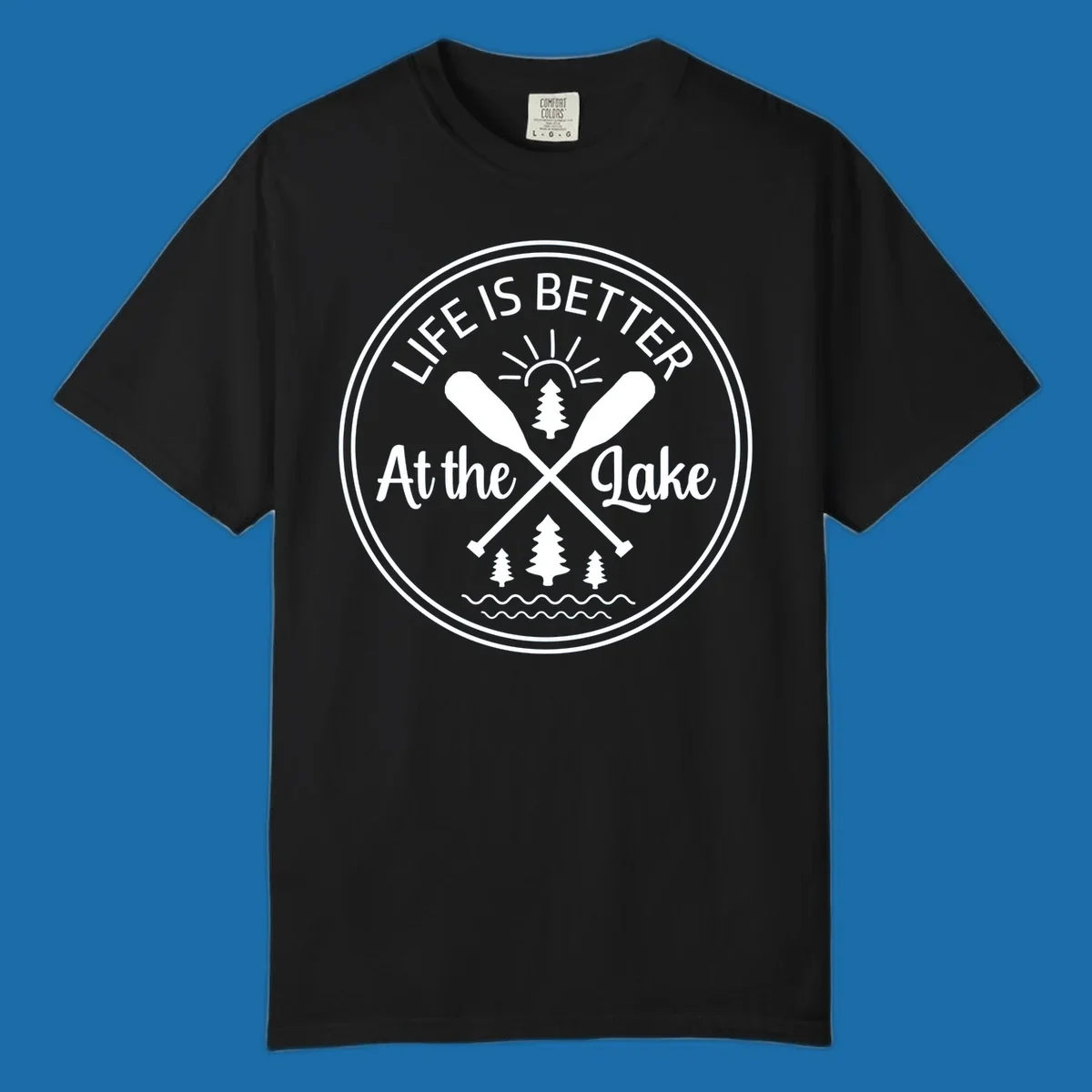 Life is better at the lake circular badge with oars, trees, sun, and waves.