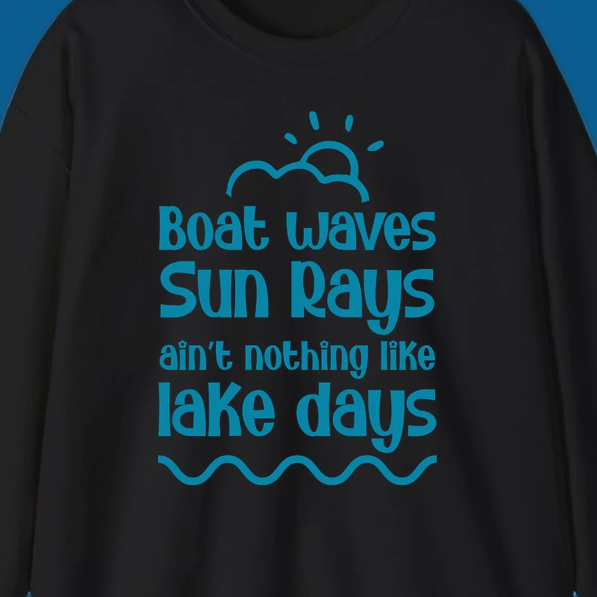 Teal text 'Boat waves Sun rays ain't nothing like lake days' with sun, cloud, and wavy line graphics, representing lake days.